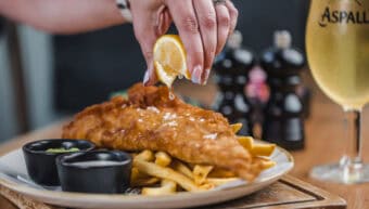 Fresh fish and chips with lemon wedge at St Christopher's Pub.