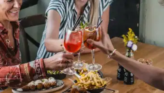 People enjoying drinks and food at St Christopher's Pub.