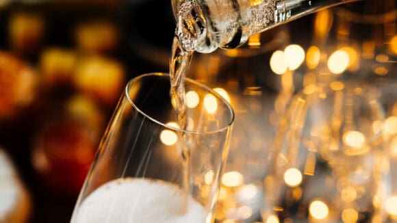 Champagne being poured into a glass at St Christopher's Pub for celebration.