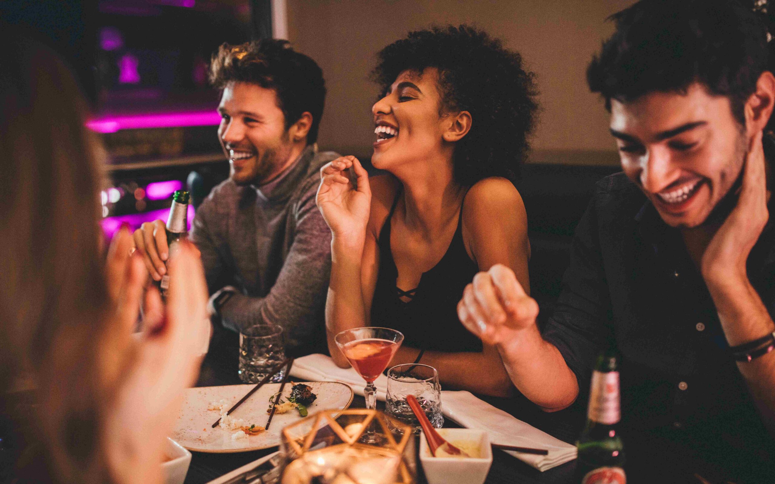 Friends laughing over dinner and drinks at The Chase Club St. Louis
