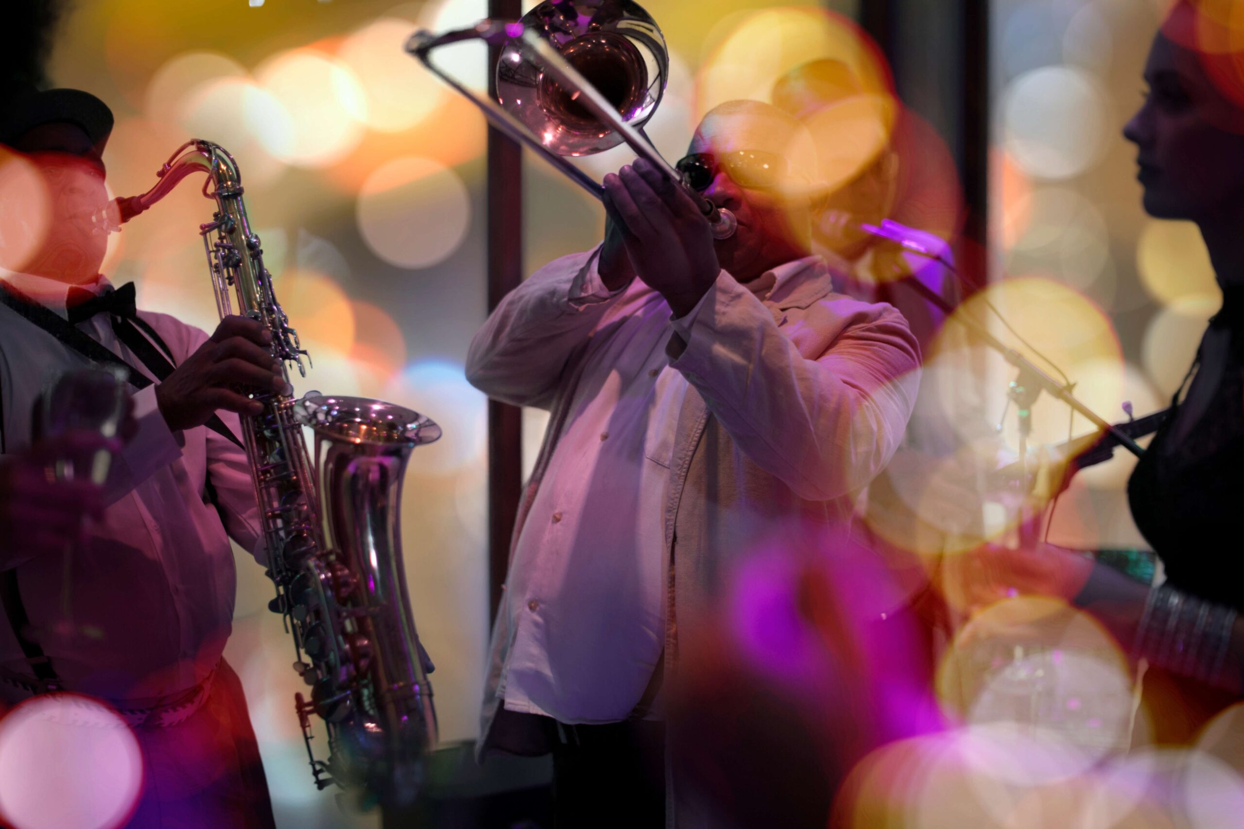 Saxophonist performing live jazz under stage lights