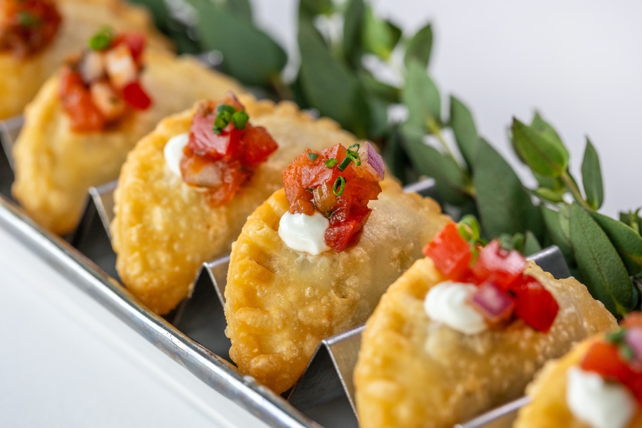 Beef empanada appetizer topped with fresh salsa and herbs at Candlewood Inn.
