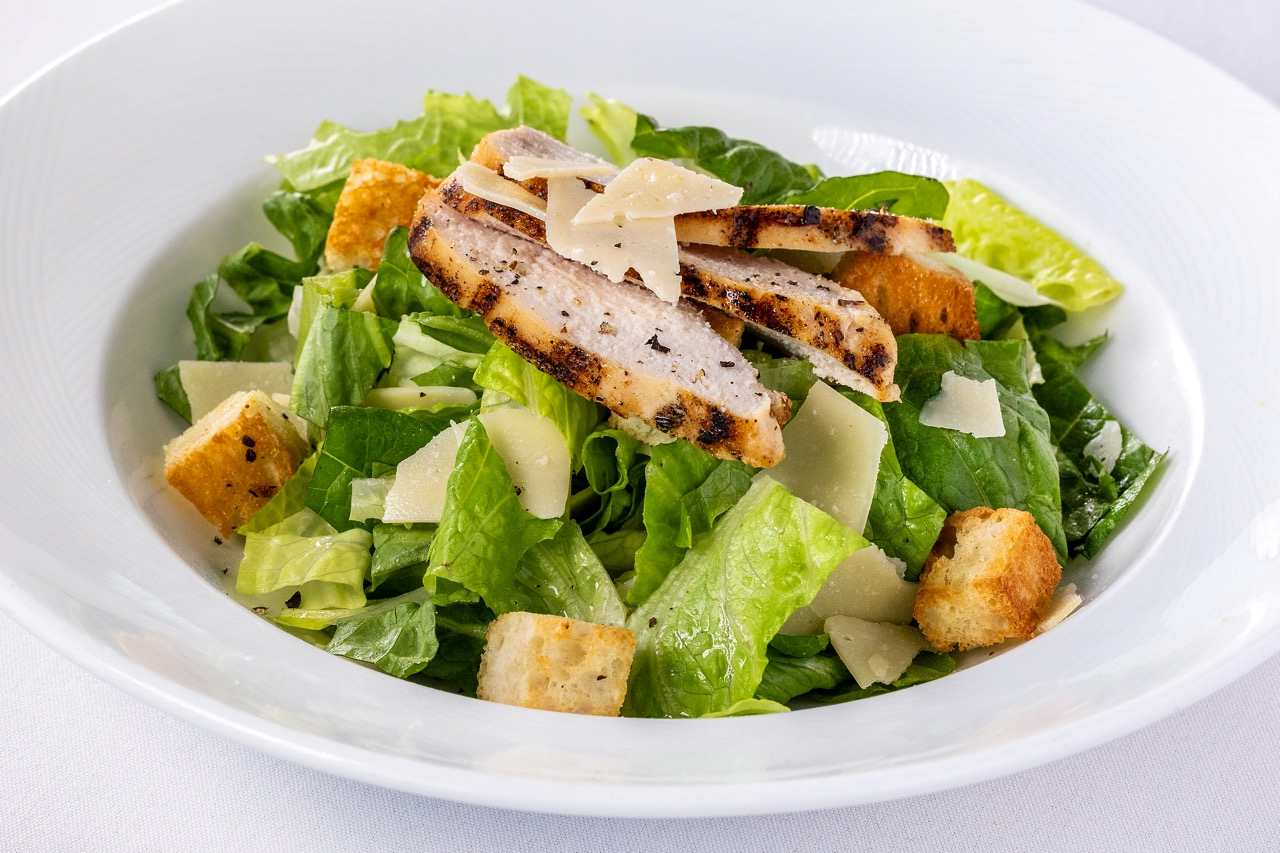 Grilled chicken Caesar salad with crisp romaine, croutons, and shaved Parmesan cheese.