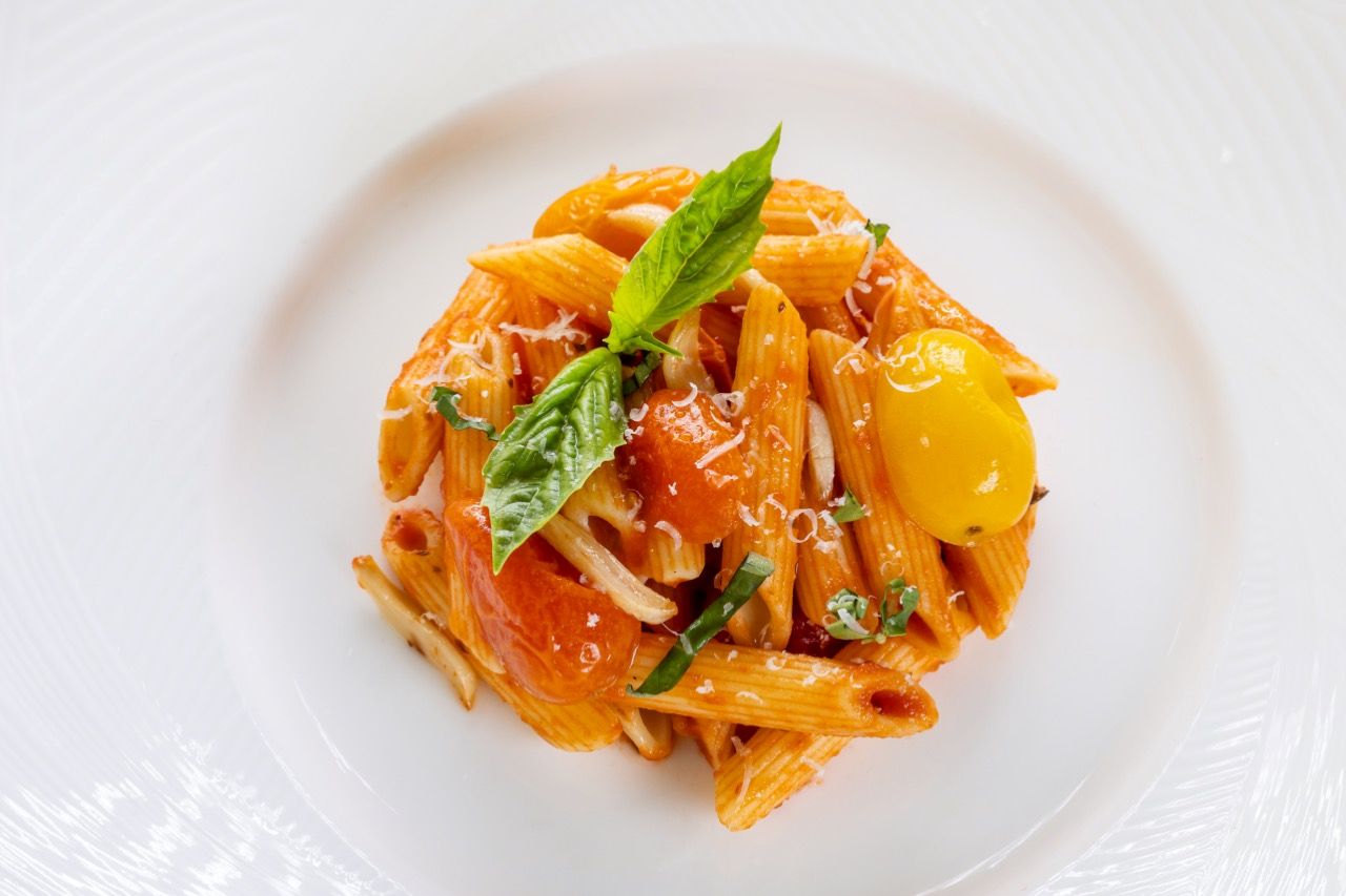 Tomato basil penne pasta with roasted tomatoes, fresh basil, and grated Parmesan cheese.