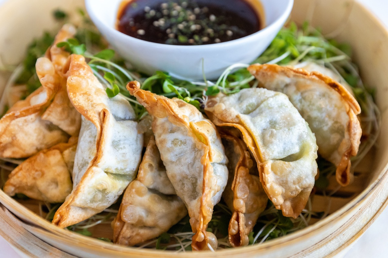 Crispy Peking duck dumplings served with dipping sauce at Candlewood Inn.
