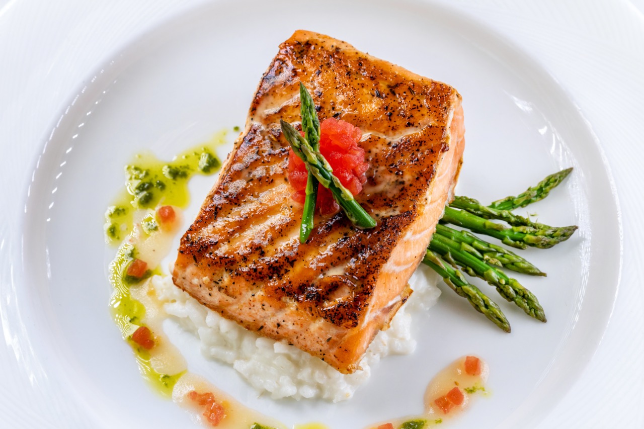 Atlantic salmon with risotto, asparagus, and citrus glaze at a Candlewood Inn reception.