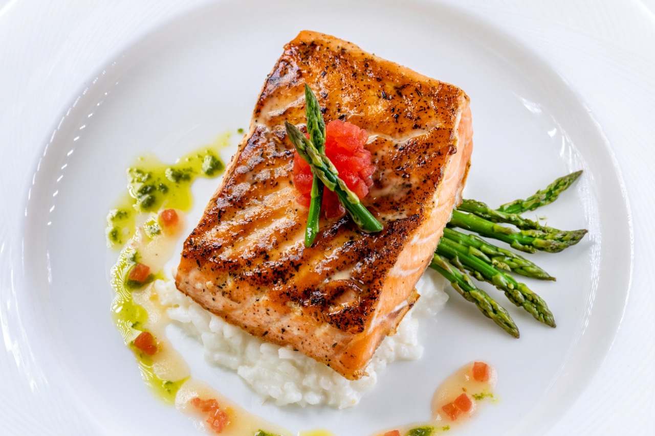 Atlantic salmon with risotto, asparagus, and citrus glaze at a Candlewood Inn reception.