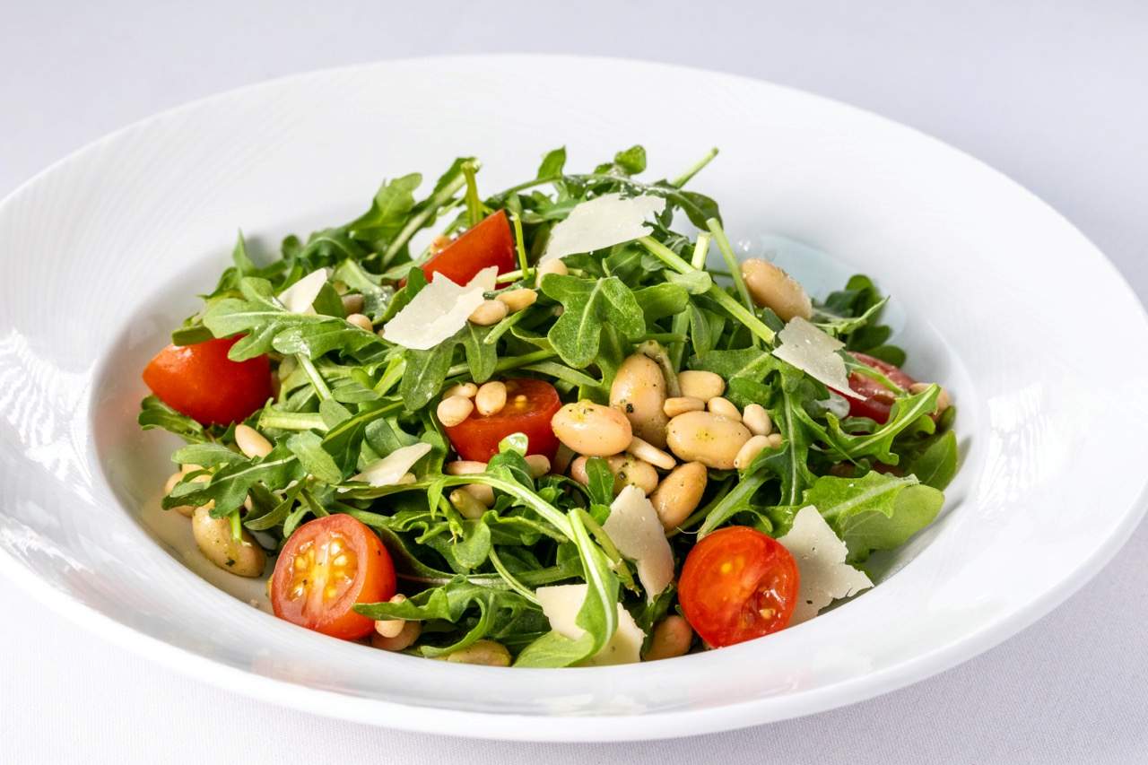 Arugula salad with cherry tomatoes, white beans, pine nuts, and shaved Parmesan at Candlewood Inn.