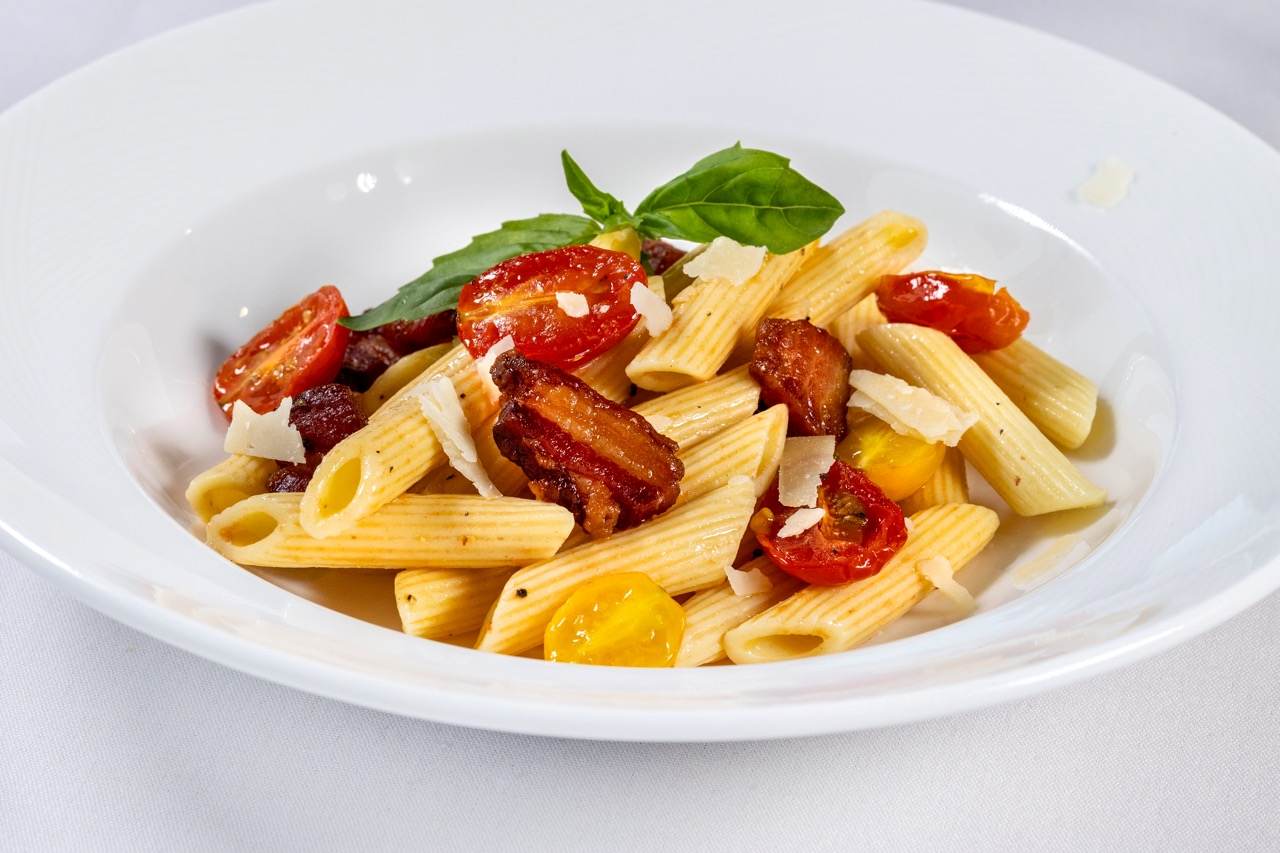 Bruschetta pasta with penne, roasted tomatoes, crispy bacon, basil, and Parmesan shavings.