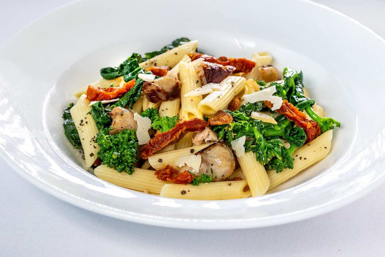 Penne Pasta with sausage, broccolini, sun-dried tomatoes, and shaved Parmesan cheese.