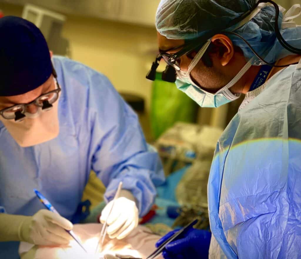 University Hospital surgeons performing an operation in an operating room