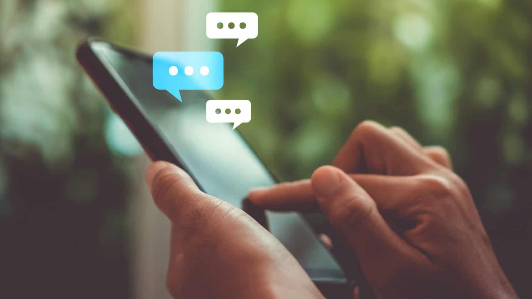 Women hand using smartphone typing, chatting conversation working home in chat box icons pop up. Social media maketing technology concept.Vintage soft color tone background.