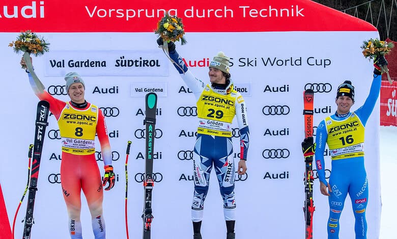 1. Alpine ski racers on podium celebrating at FIS Ski World Cup in Val Gardena, showcasing winter sports excellence and ski competition medals.