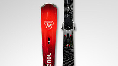 Pair of Rossignol Hero MT-Ti skis designed for advanced winter skiing, featuring a sleek black and red design with high-performance features for optimal snow traction.