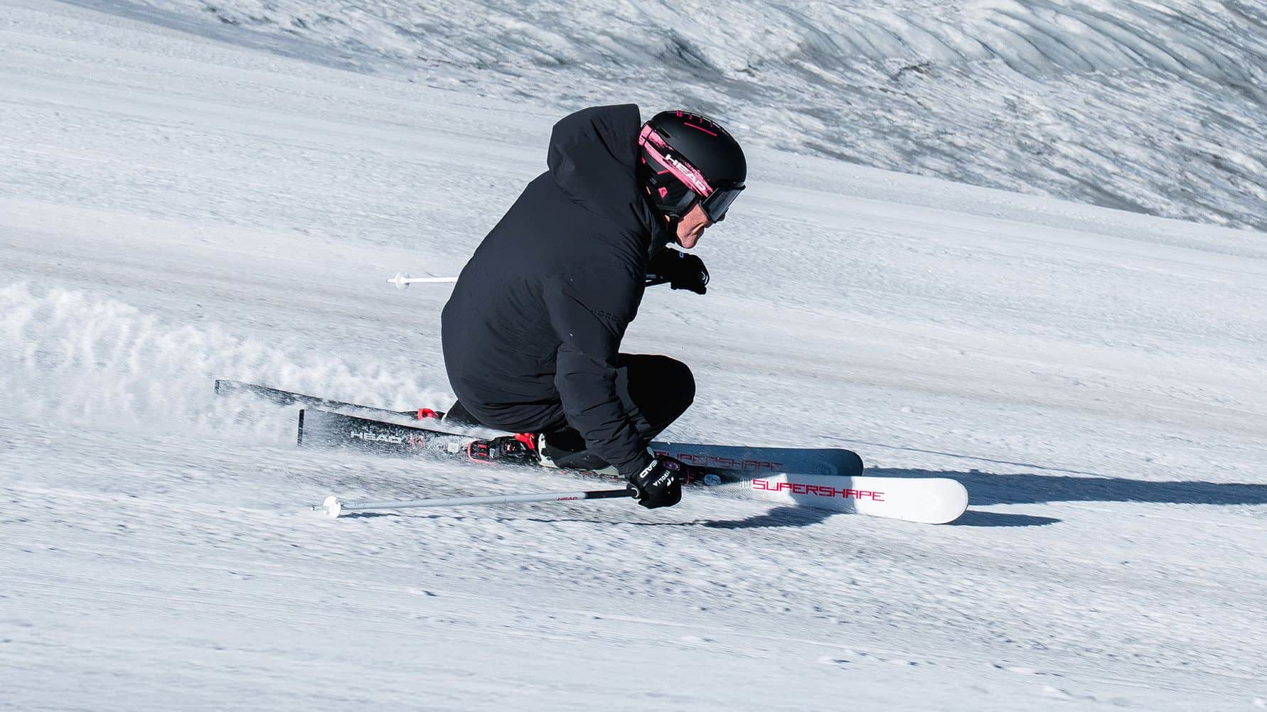 Skier carving on snow with HEAD Supershape skis
