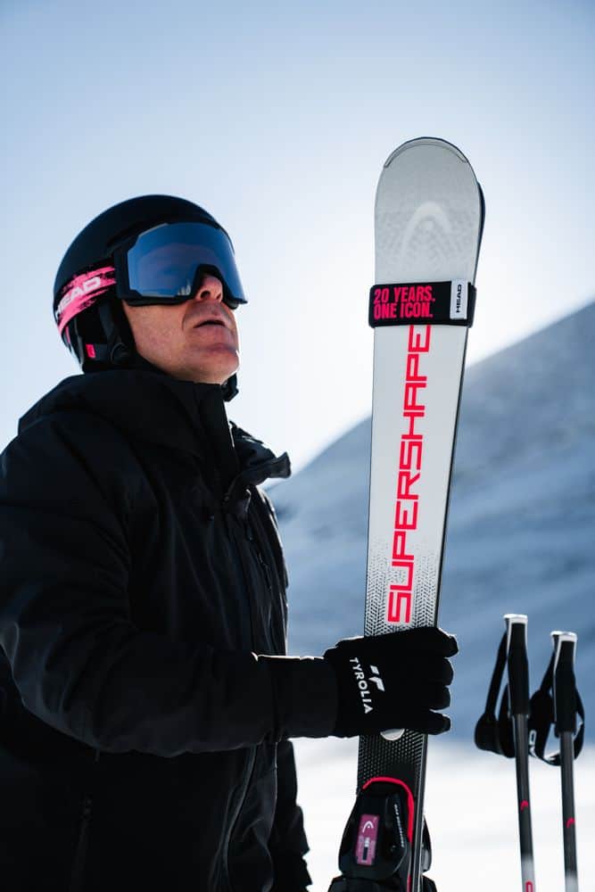 Skier holding a HEAD Supershape anniversary ski