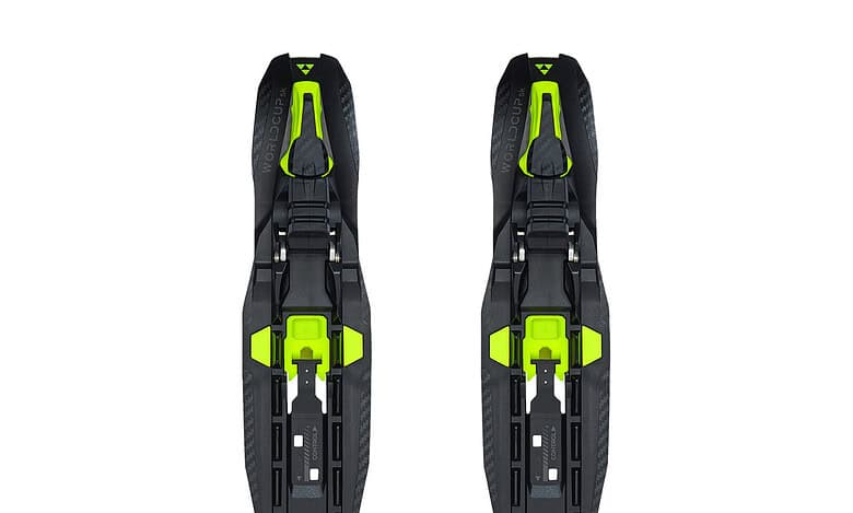 Pair of black and neon green ski bindings designed for winter sports enthusiasts, featuring adjustable straps and durable construction for optimal performance on snow.
