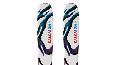 Pair of Salomon snow skis with vibrant, abstract design in blue, black, purple, and red on a white background, ideal for winter sports enthusiasts.