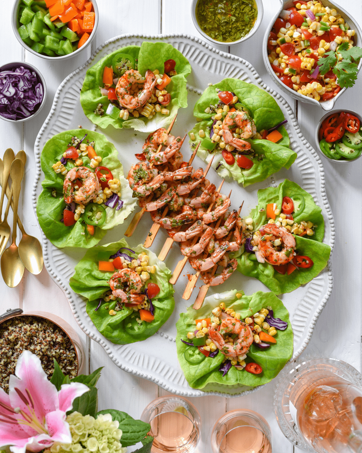 A platter of shrimp lettuce wraps and chimichurri shrimp skewers.