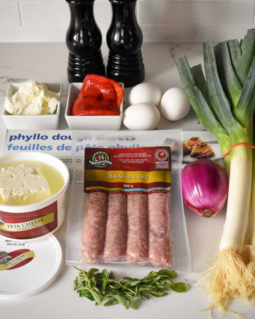 Ingredients laid out to make a Sausage and Feta Phyllo Pie.
