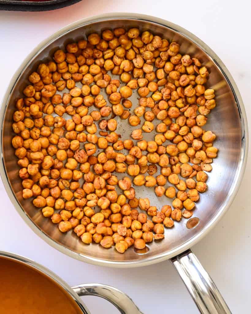 A skillet with golden-brown roasted chickpeas.