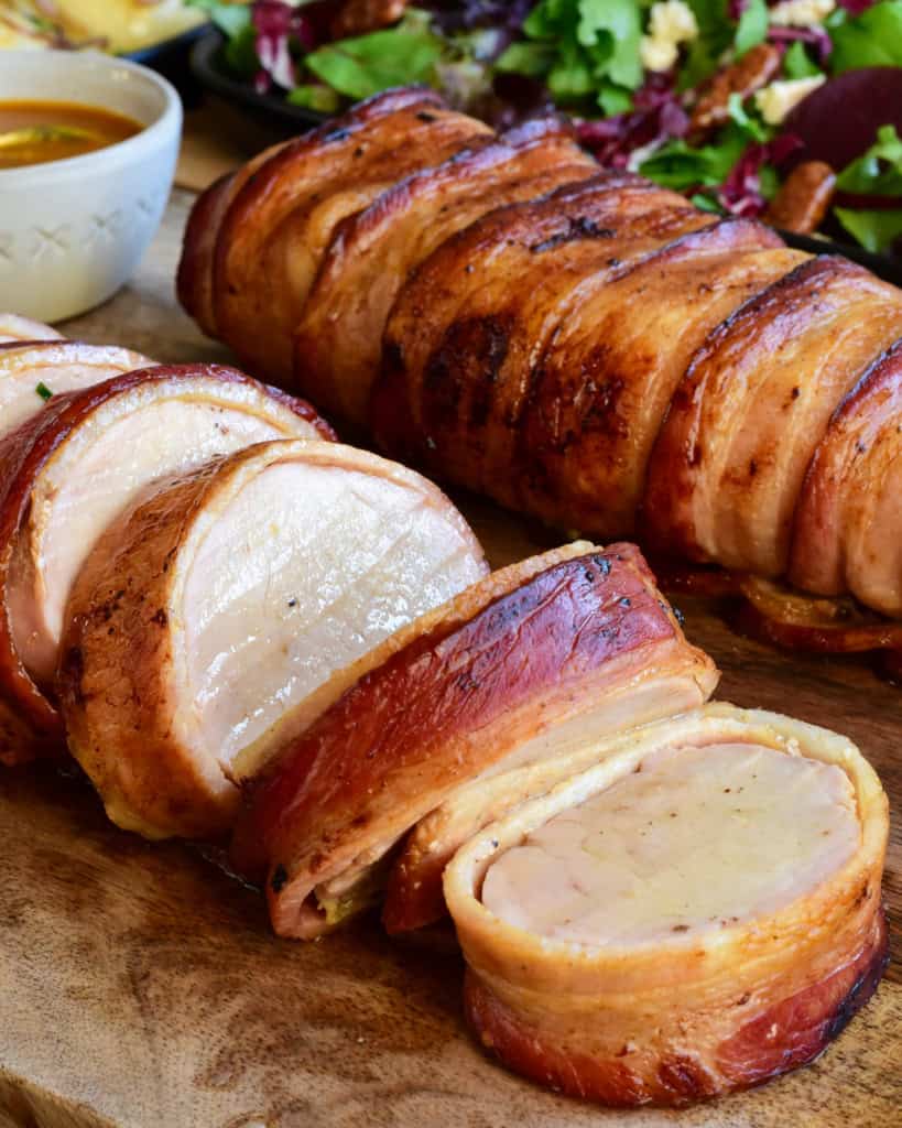 Sliced pork tenderloin wrapped in bacon.