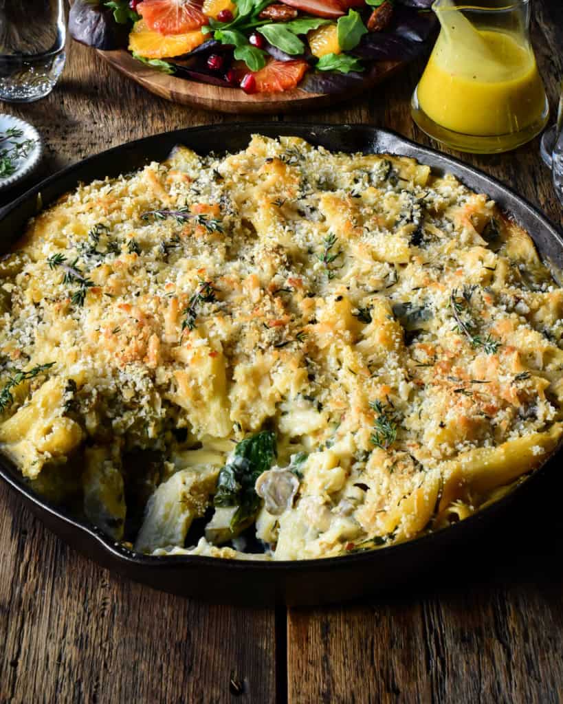 A cast-iron skillet with a creamy cauliflower pasta bake.