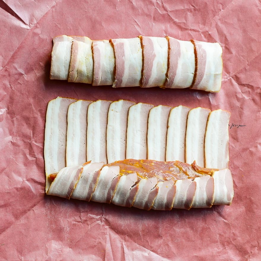 One bacon wrapped pork tenderloin and one half wrapped.