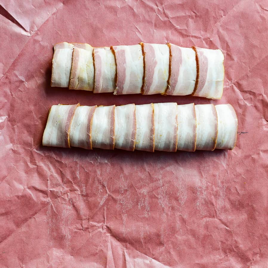 Two bacon wrapped pork tenderloins.