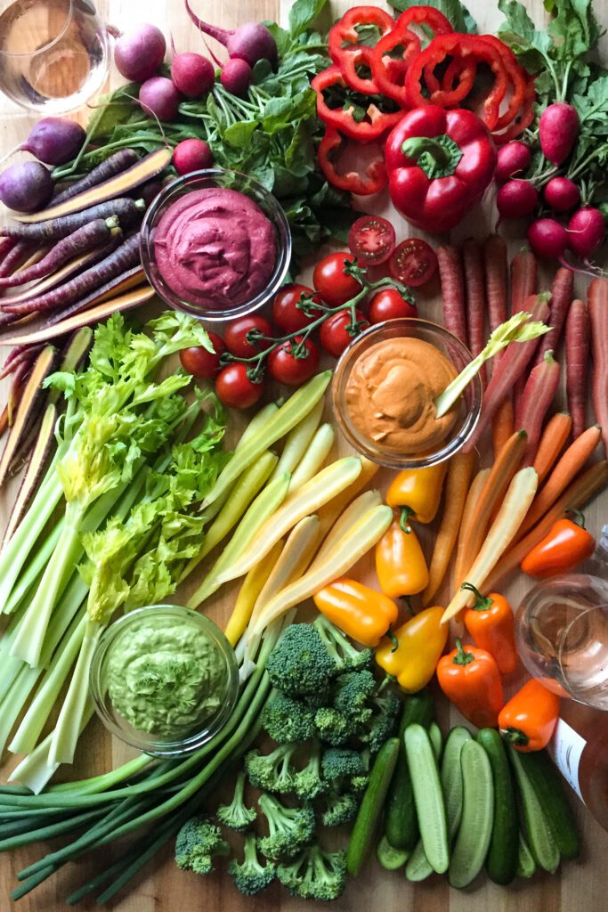 A very colourful display of veggies and three dips. 