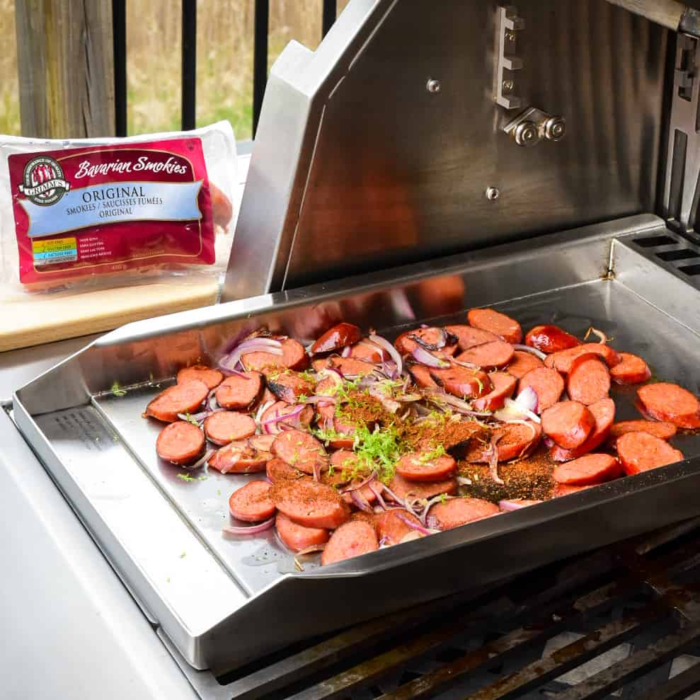 Sliced sausages on the grill