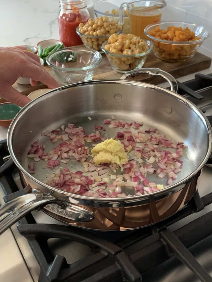 A pan with sautéed onions and garlic.