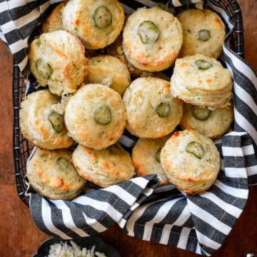 A basket of herb and garlic cheese jalapeno biscuits served with gravy.