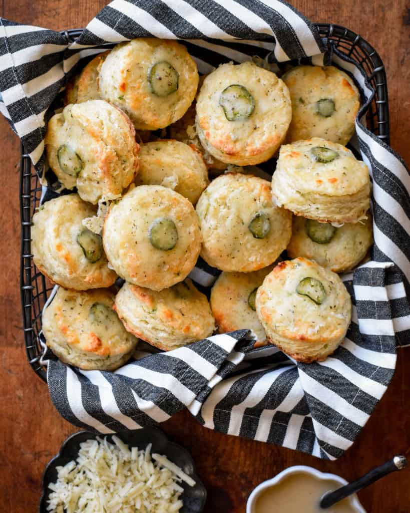 A basket of herb and garlic cheese jalapeno biscuits served with gravy.