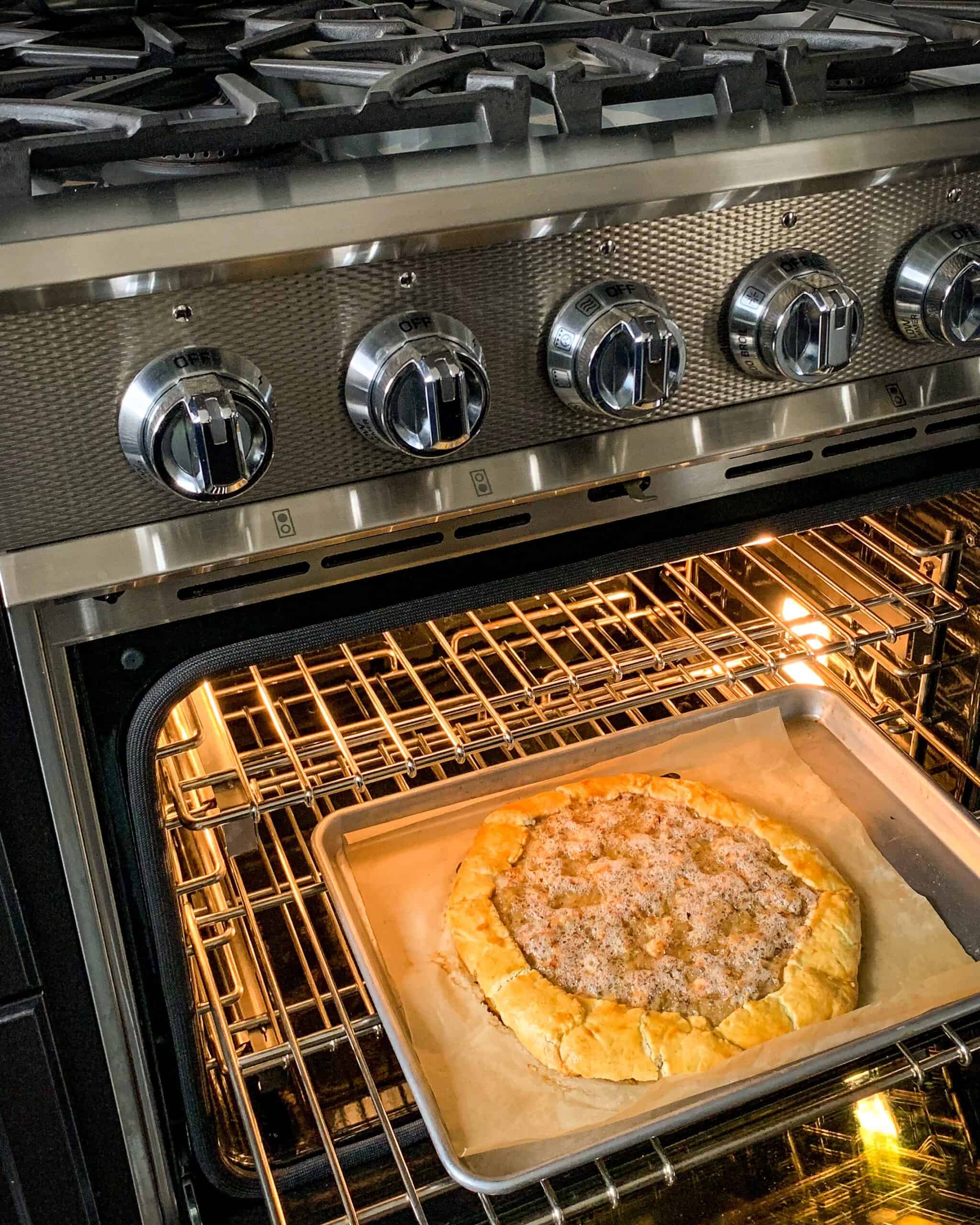 A finished bubbling galette coming out of the oven.