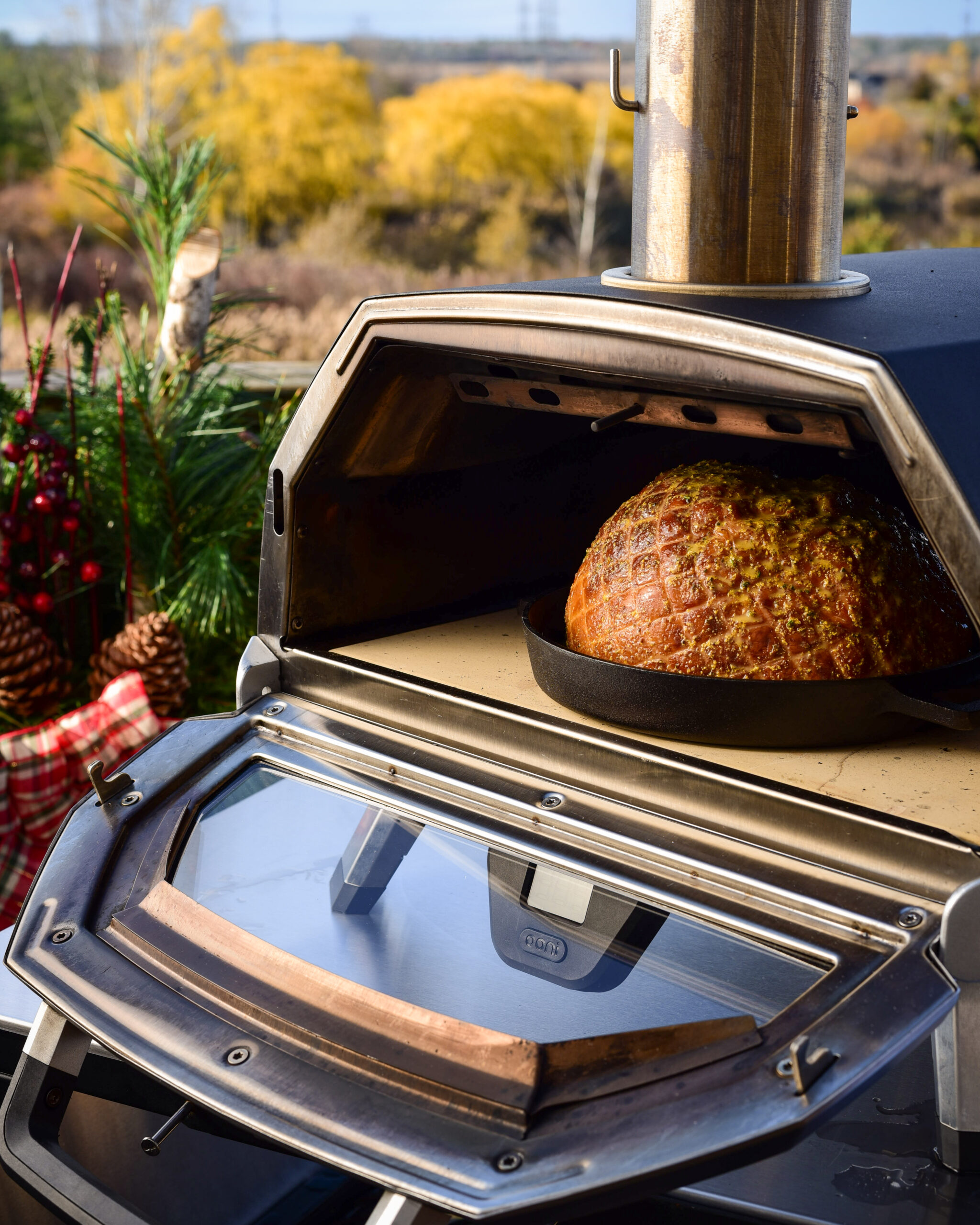 A ham is placed inside the Ooni wood oven.
