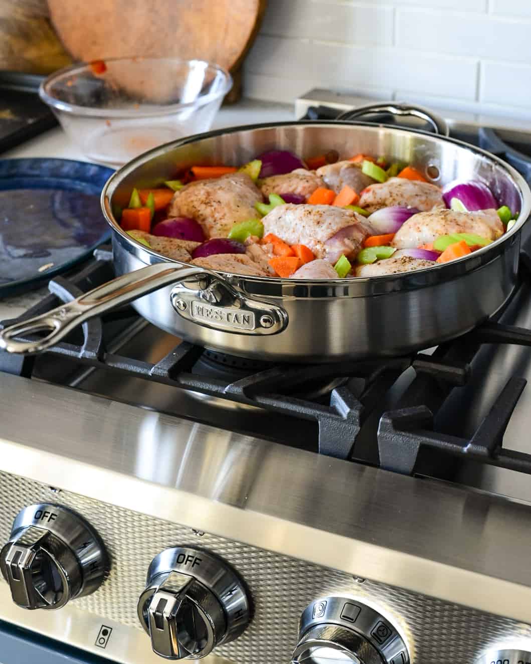 Baked Harissa Spiced Chicken is nestled in the pan with vegetables.