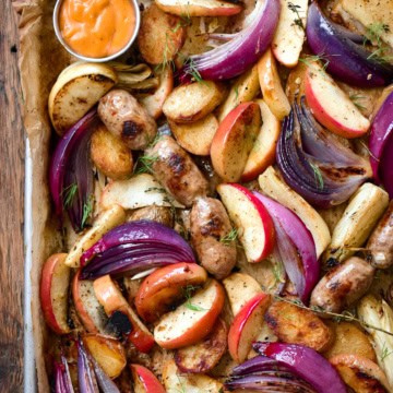A sheet pan with roasted apples, fennel, onions and sausages.