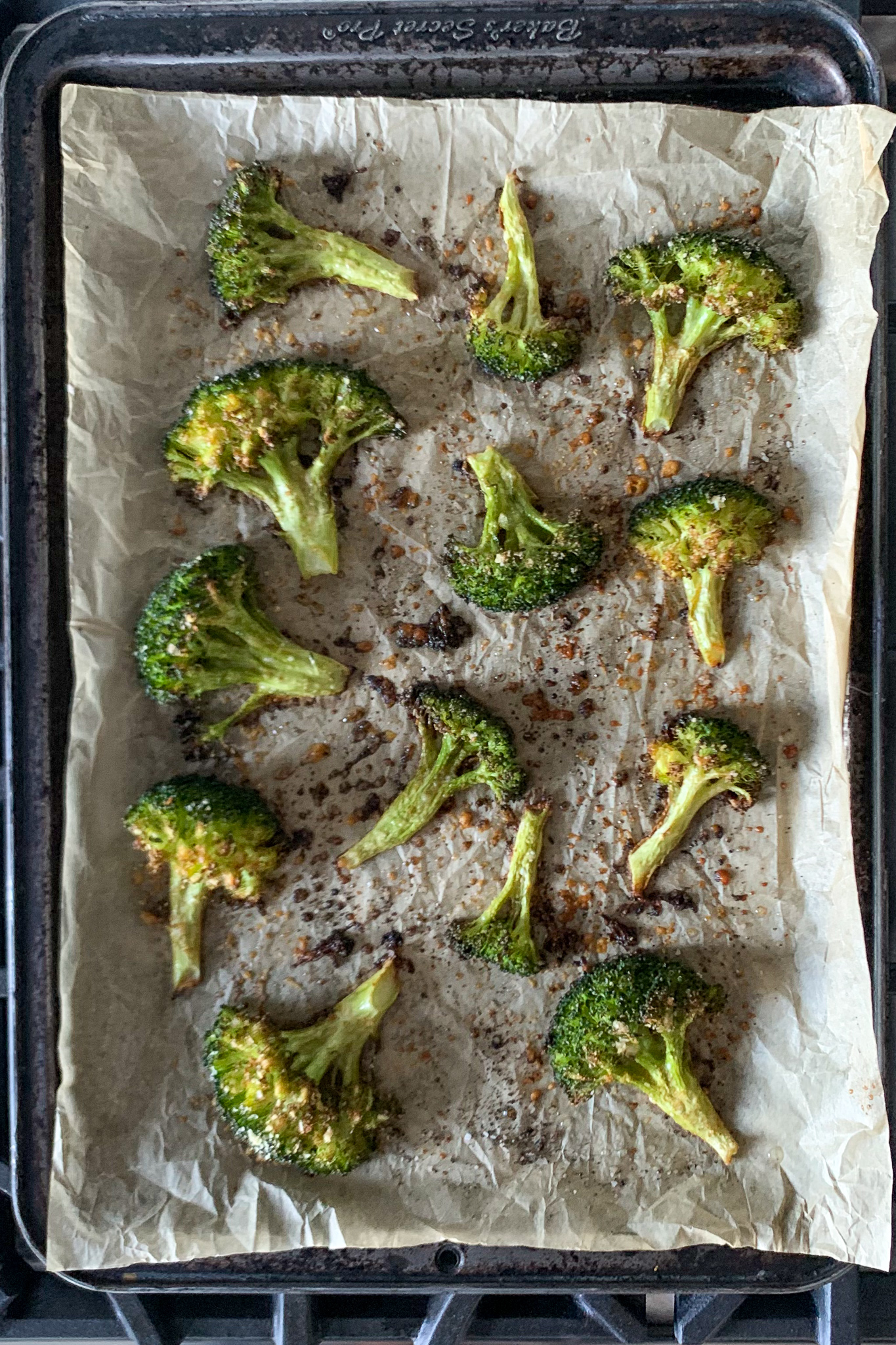 Roasting broccoli on parchment paper.