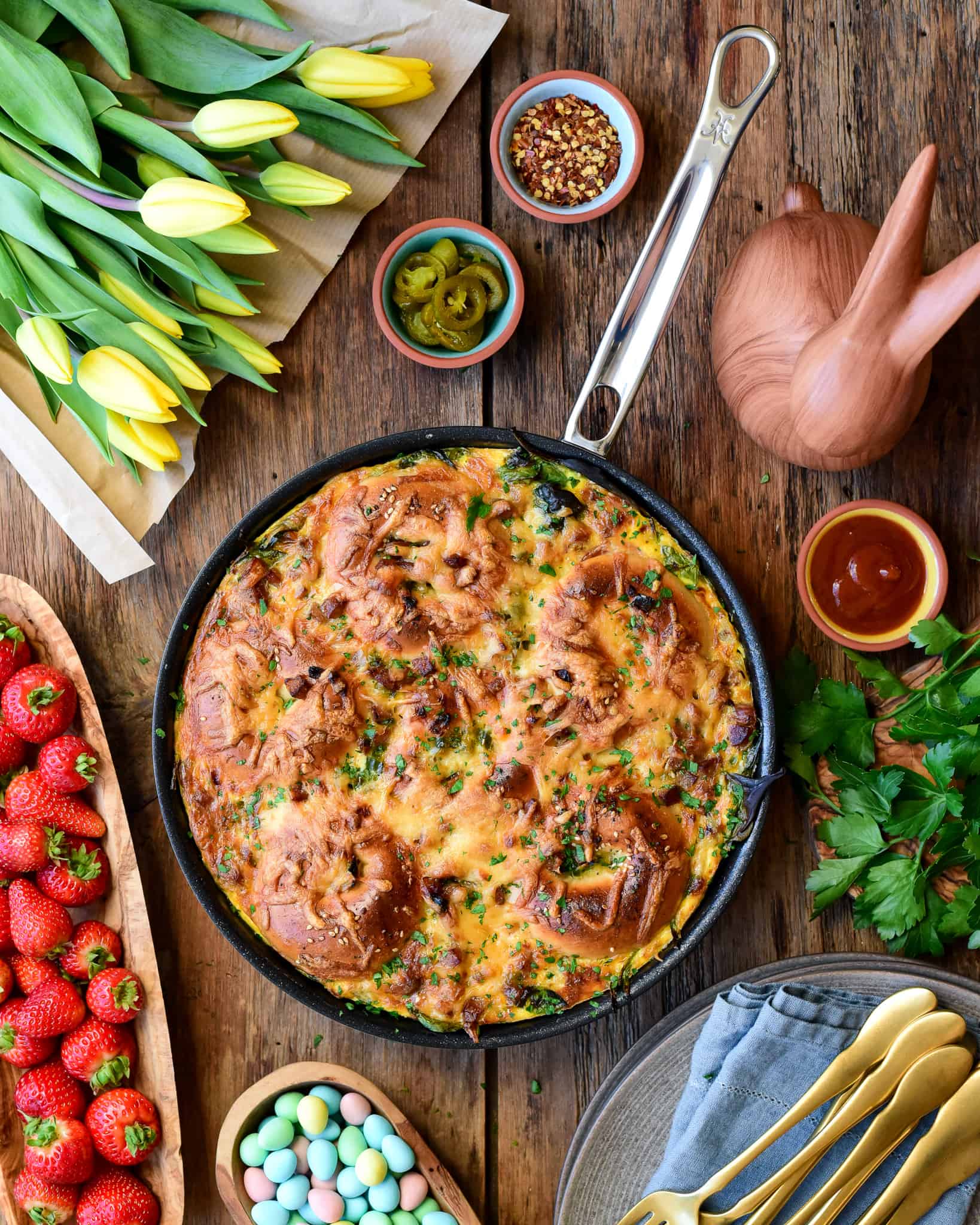 A skillet of a bagel bake on an Easter themed table.