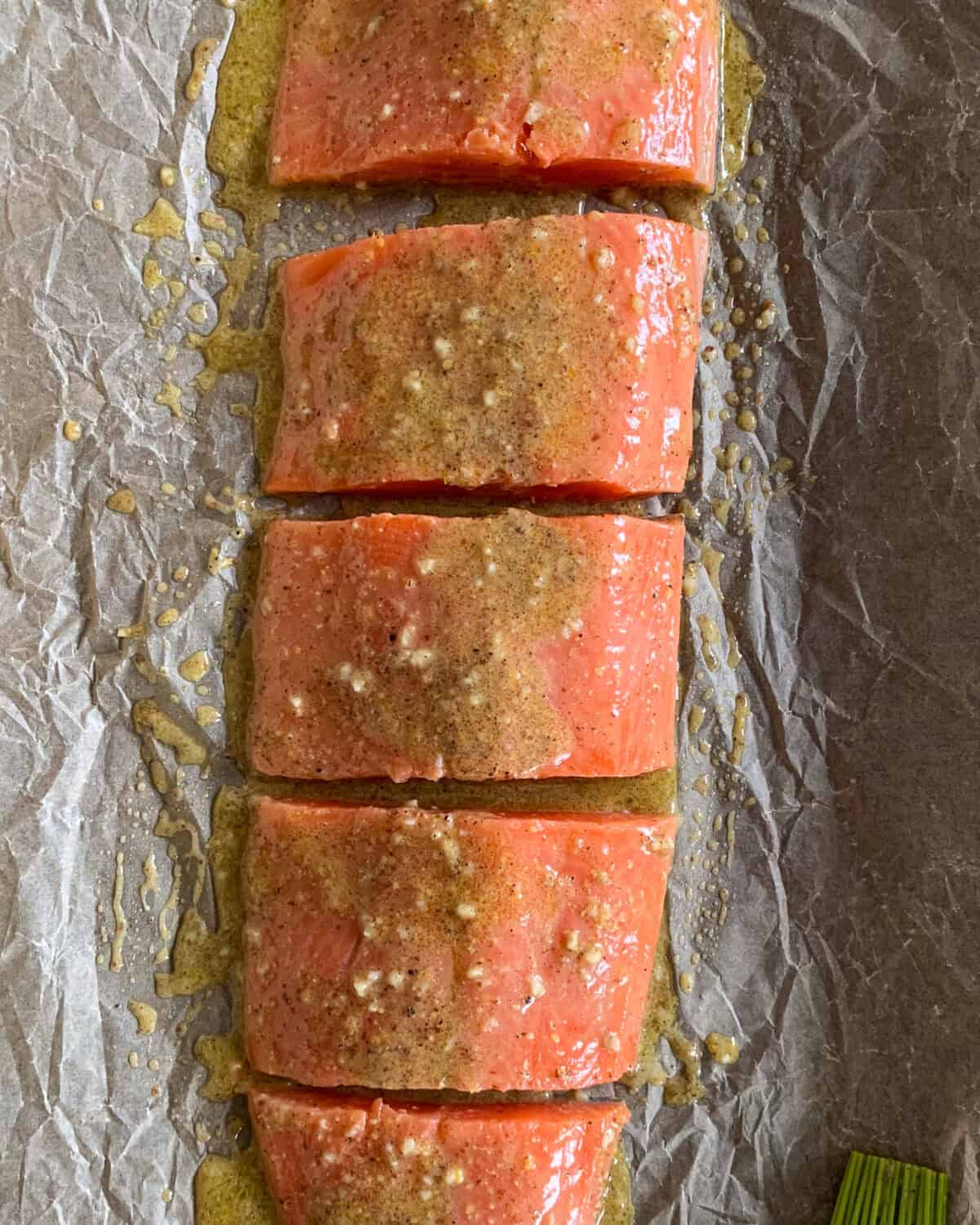 A sheet pan of portioned marinated Coho salmon for a Niçoise Salad with Salmon.