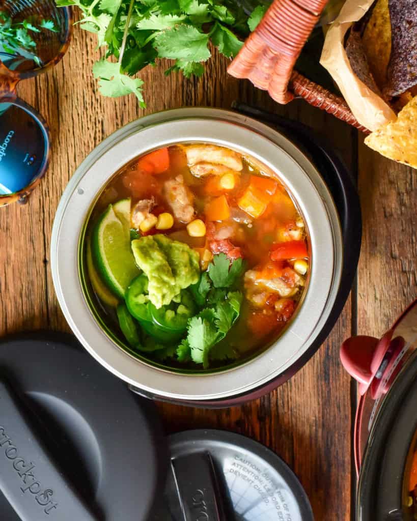 A bowl of Fiesta Chicken Chili in a small portable crockpot.