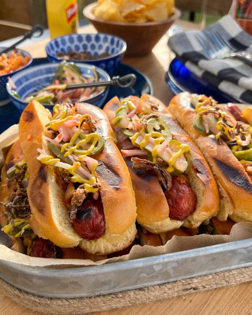 A close up image of a stack of smokies in a galvanized tray.