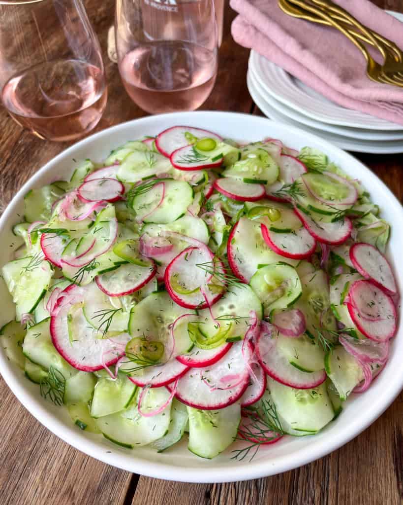 A bowl of cucumber, radish, jalapeño salad with dill.