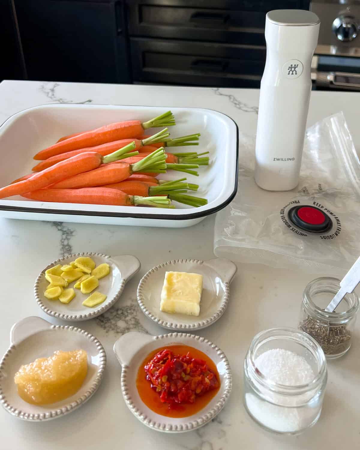Ingredients for carrots and hummus with a SV pump and bag.