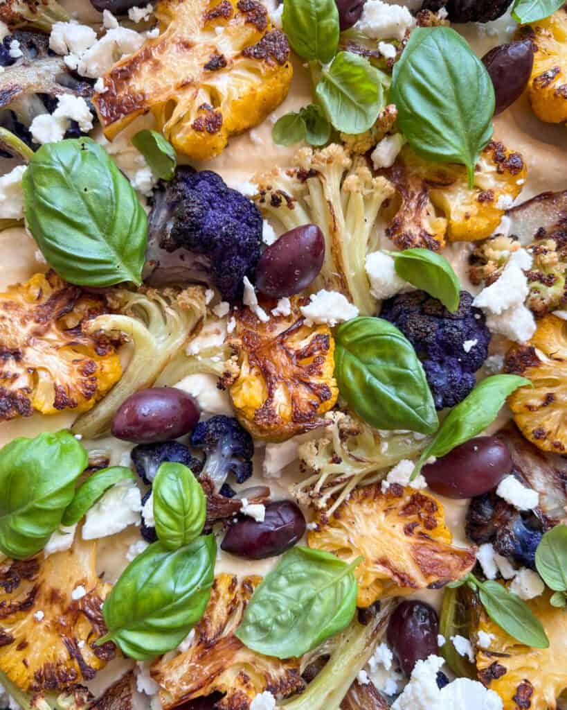 A close up image of Roasted Cauliflower with Hummus Yogurt Dip