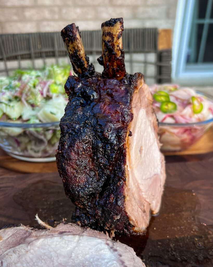 A jerk 2 bone pork roast cut open with a beautiful crust.