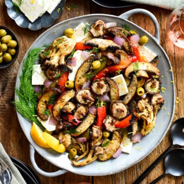 A plate of food with a variety of grilled mushrooms and other ingredients.
