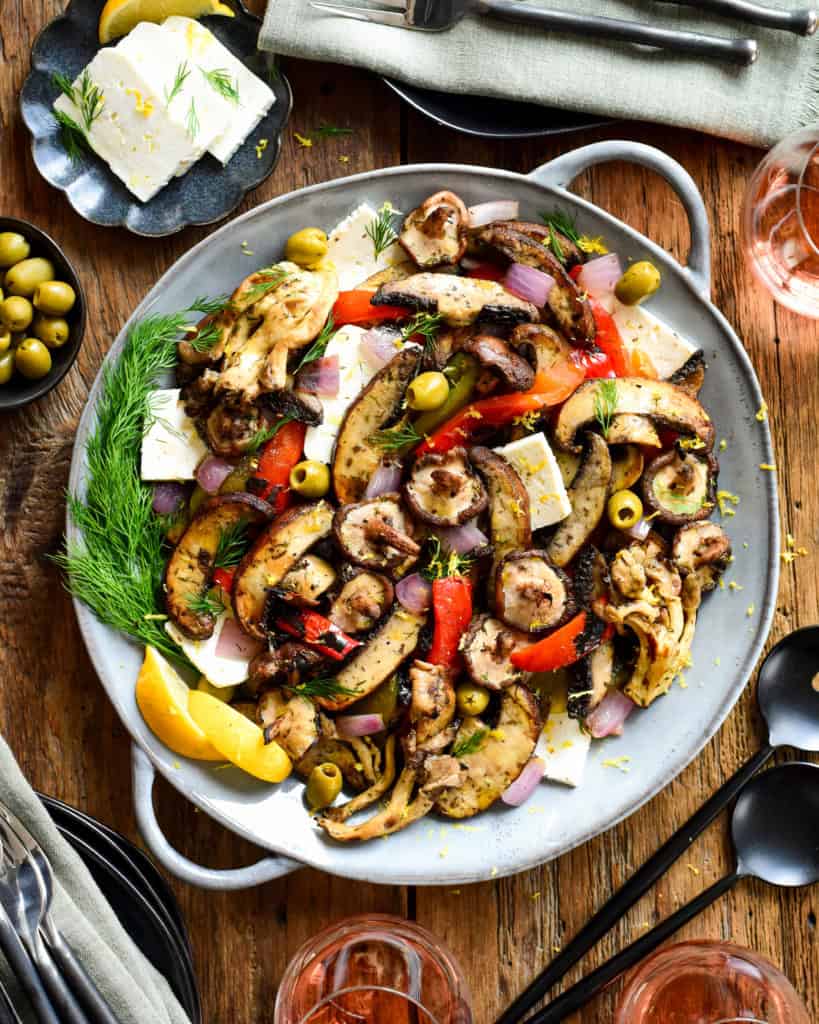 A plate of food with a variety of grilled mushrooms and other ingredients.