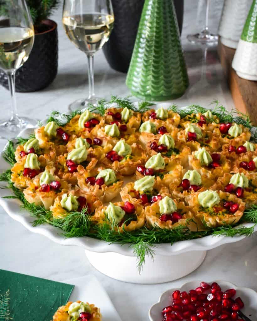 A plate of mini quiche appetizers with crema.